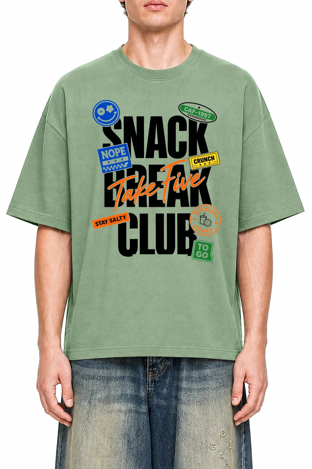 Snack Break Club Light Green graphic T-shirt on model, front view