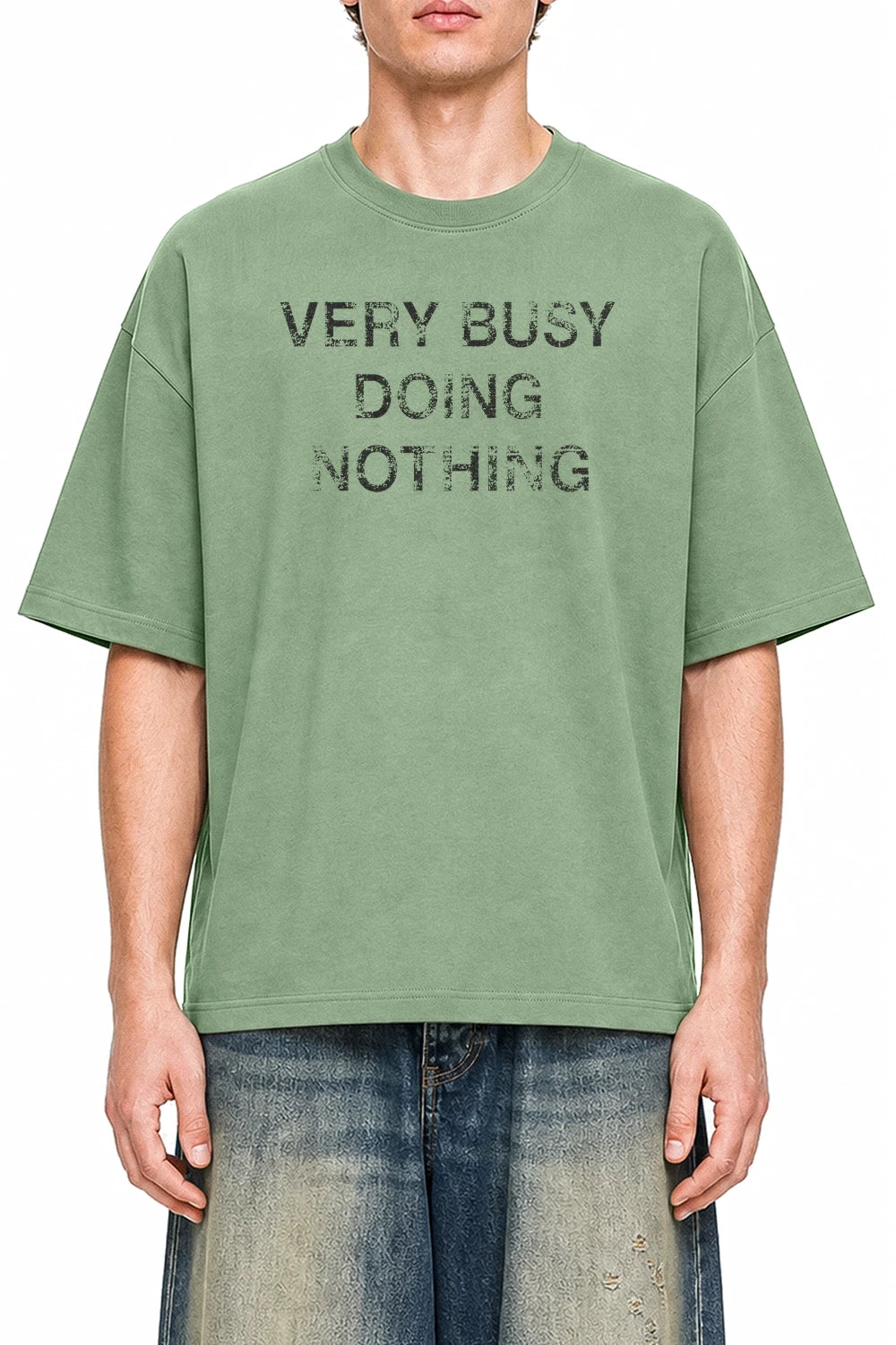 Very Busy Doing Nothing Light Green graphic T-shirt on model, front view